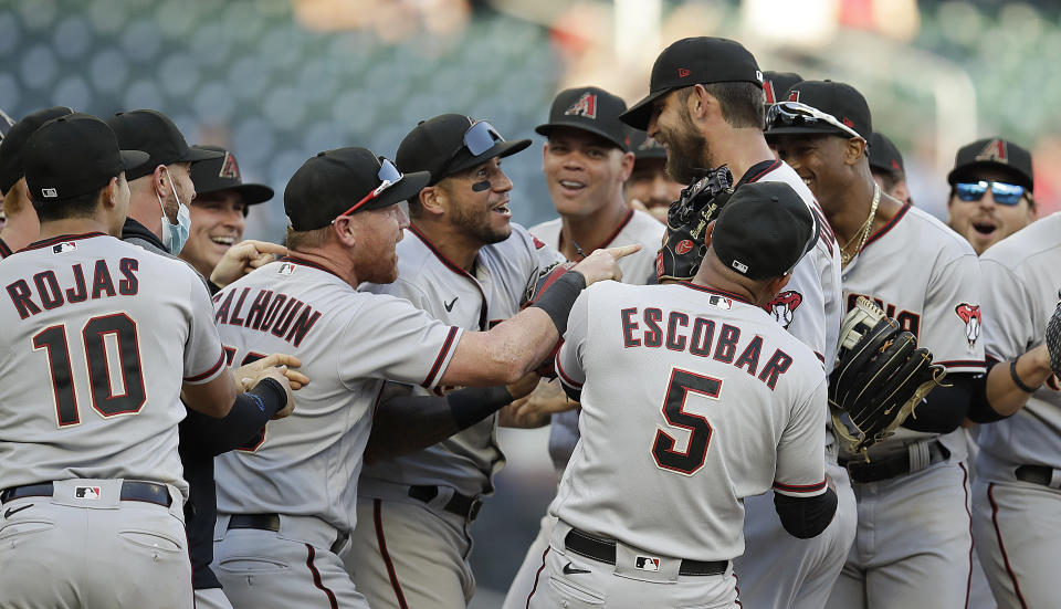 Arizona Diamondbacks pitcher Madison Bumgarner, center right, is congratulated after pitching a seven-inning no-hitter against the Atlanta Braves at the end of the second baseball game of a doubleheader Sunday, April 25, 2021, in Atlanta. (AP Photo/Ben Margot)