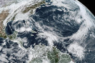 FILE - This Tuesday, Nov. 10, 2020, satellite image made available by NOAA shows Tropical Storm Eta at 10:40 a.m. EST in the Gulf of Mexico, Theta, right, and a tropical wave to the south that became Tropical Storm Iota. An overheating world obliterated weather records in 2020 — an extreme year for hurricanes, wildfires, heat waves, floods, droughts and ice melt — the United Nations’ weather agency reported Wednesday, Dec. 2, 2020. (NOAA via AP)