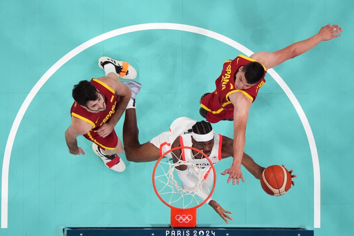 Aug 2, 2024; Villeneuve-d'Ascq, France; Canada guard Shai Gilgeous-Alexander (2) shoots against Spain centre Jaime Pradilla (4) in the second half in a menâ€™s group A basketball game during the Paris 2024 Olympic Summer Games at Stade Pierre-Mauroy. Mandatory Credit: John David Mercer-USA TODAY Sports