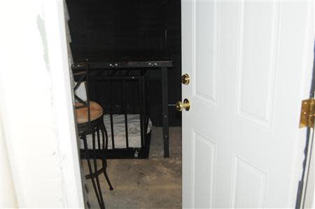 A steel cage (approximately 3' wide, 2' high and 4' long) with multiple locking devices is shown in a July 27, 2012 handout photo released by the U.S. Attorney's Office after a search warrant was executed at the Worcester, Massachusetts house of Geoffrey Portway, 40. REUTERS/U.S. Attorney's Office/Handout via Reuters