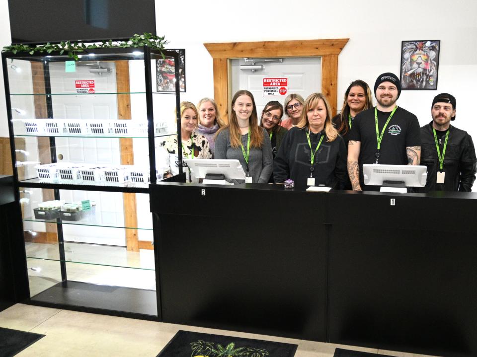 Employees of California Michigan Cannabis Company stocking product this week for opening.