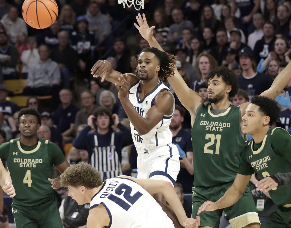 Utah State guard Josh Uduje passes off to a teammate during the Aggies’ win over No. 13 Colorado State Jan. 6 at the Spectrum in Logan. | Jeff Hunter