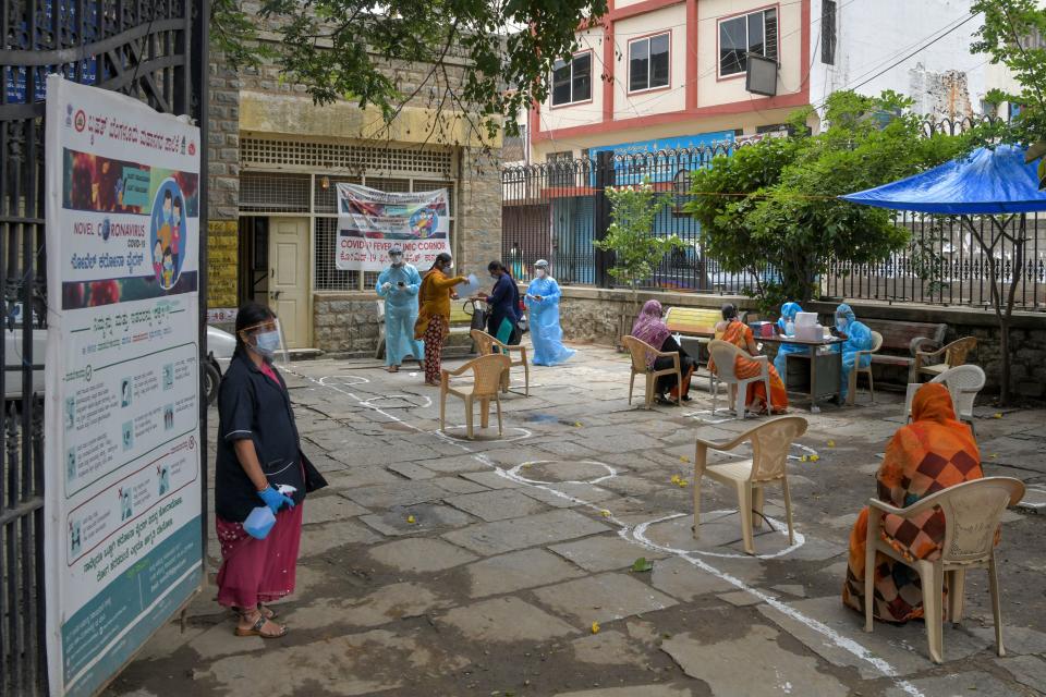 People wait for their turn to consult with doctors at a COVID-19 point in Bangalore (Photo by Manjunath Kiran / AFP) (Photo by MANJUNATH KIRAN/AFP via Getty Images)