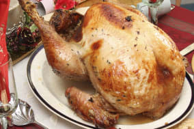 festivals, religious, christmas, food cooked poultry. a whole turkey ready for carving on a table laid for christmas lunch....