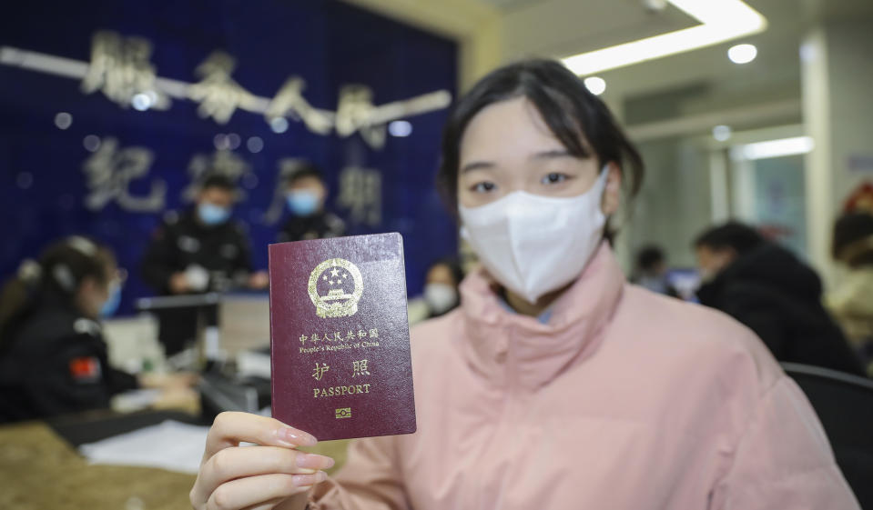 HUAI'AN, CHINA - FEBRUARY 9, 2023 - People show their passports in Huai 'an, East China's Jiangsu province, Feb 9, 2023. Starting from February 6, 2023, the Ministry of Culture and Tourism has resumed the operation of outbound group Tours and air ticket + hotel services for Chinese citizens to 20 countries by travel agencies and online tourism companies across the country on a trial basis. (Photo credit should read CFOTO/Future Publishing via Getty Images)