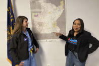 FILE - Two Democratic candidates for a U.S. House of Representatives seat, Kathleen Harder, left and Loretta Smith, stand next to a map of Oregon's new 6th congressional district on April 12, 2022 in Salem, Ore. They and four other candidates are criticizing the House Majority PAC's support for rival Democratic candidate Carrick Flynn. (AP Photo/Andrew Selsky, File)