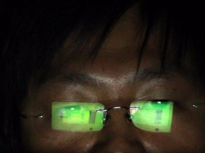 A hacker, who requests not to have his name revealed, works on his laptop in his office in Taipei July 10, 2013. REUTERS/Pichi Chuang