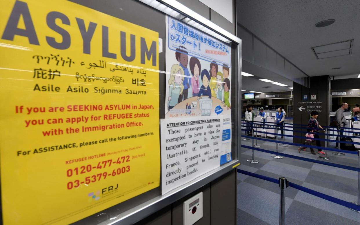 A poster near the passport control counter of the immigration office at the Narita International airport - AFP