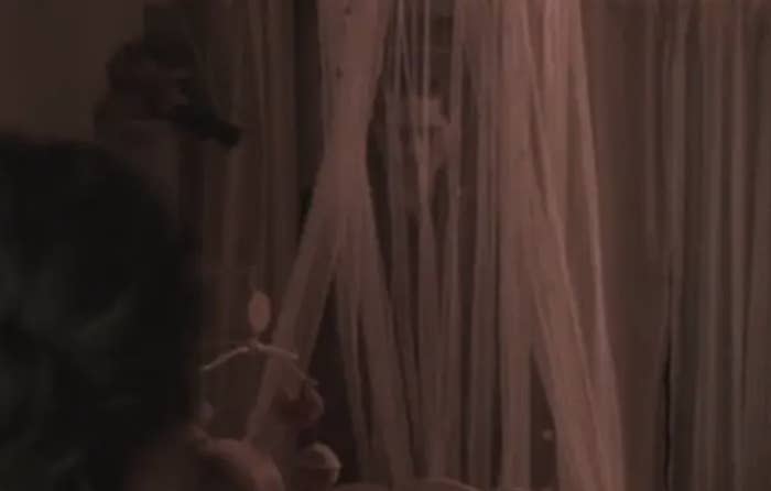 A ghost from "Insidious" looking through a canopy