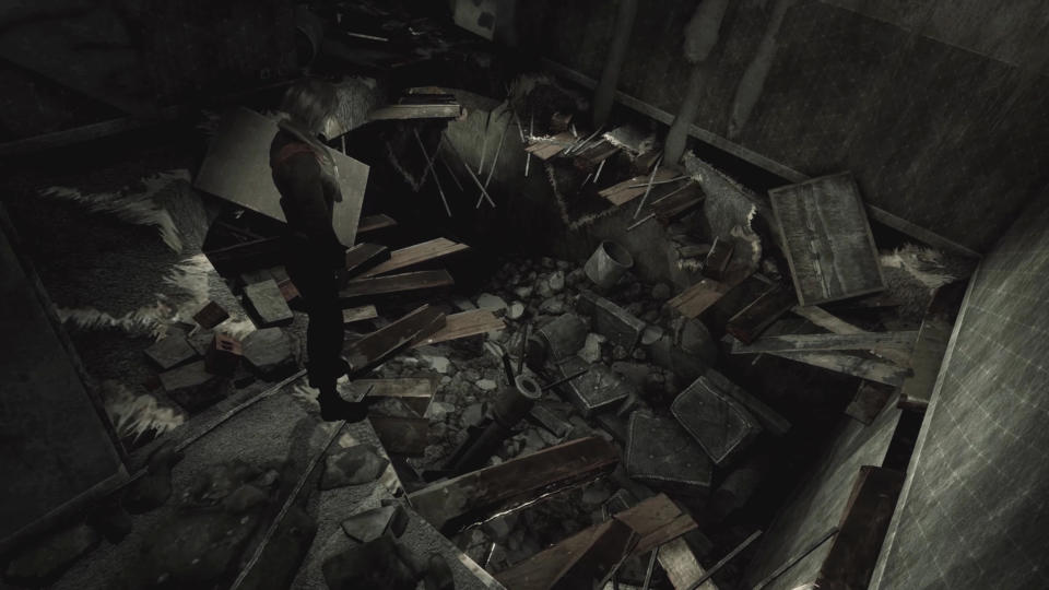 A still from Hollowbody showing the main character Mica standing over a large hole in an apartment floor, with debris all over