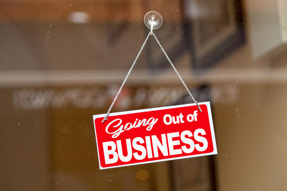 "Going out of business" sign hanging in a window