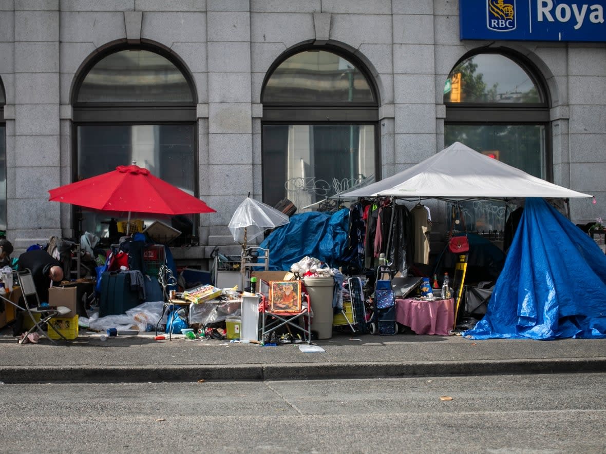 Makeshift structures seen on Hastings Street in Vancouver in early August, before an order to remove them took effect.  (Ben Nelms/CBC - image credit)