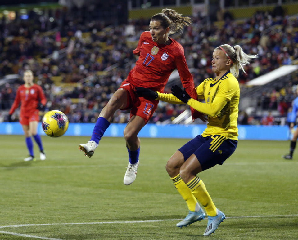 United States forward Tobin Heath, left, passes the ball in front of Sweden defender Hanna Glas during the first half of a women's international friendly soccer match in Columbus, Ohio, Thursday, Nov. 7, 2019. (AP Photo/Paul Vernon)