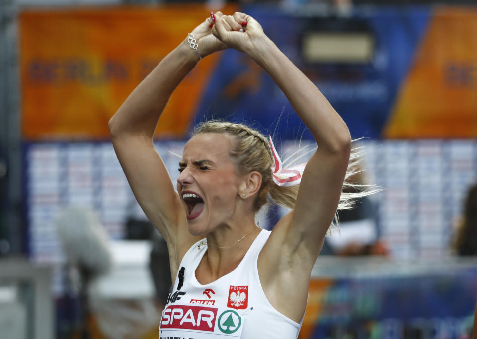 Poland's Justyna Swiety-Ersetic celebrates after winning the gold medal after the women's 400-meter final at the European Athletics Championships at the Olympic stadium in Berlin, Germany, Saturday, Aug. 11, 2018. (AP Photo/Matthias Schrader)