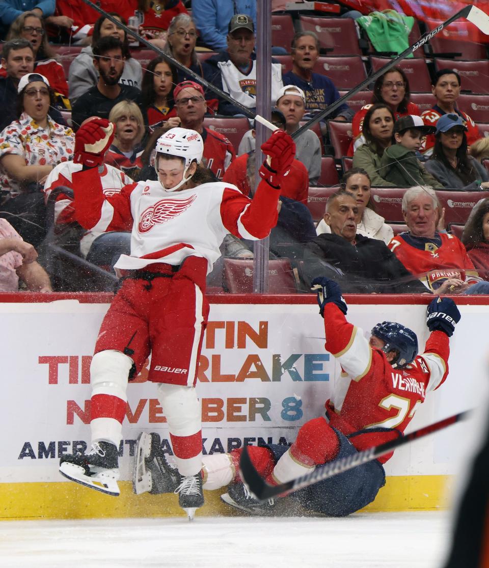Moritz Seider (53) of the Detroit Red Wings checks Carter Verhaeghe (23) of the Florida Panthers during the second period at Amerant Bank Arena on March 30, 2024 in Sunrise, Florida.