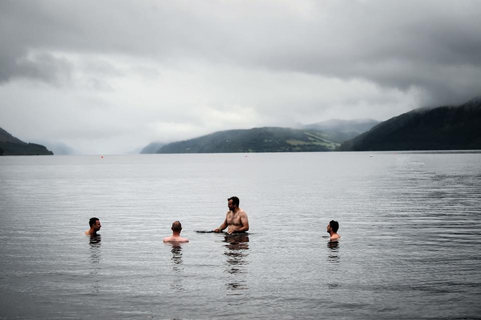 People swim off Dores Beach on Loch Ness in Scotland on Aug. 27, 2023.