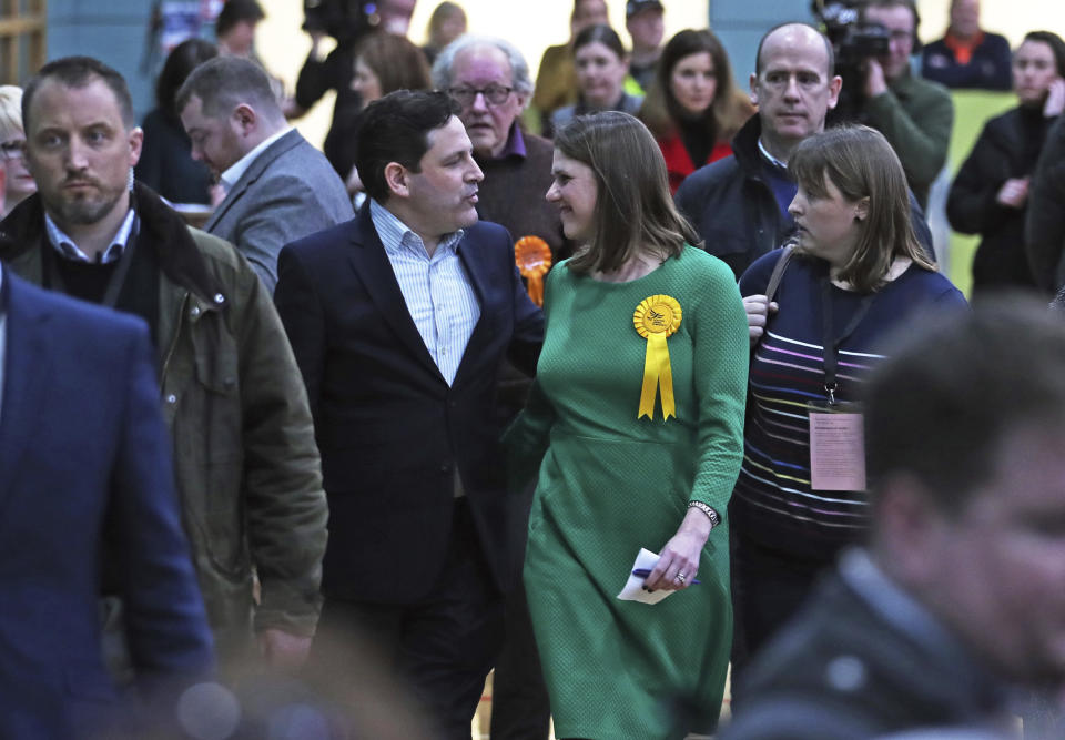 Lib Dem leader Jo Swinson with her husband, Duncan walks to the count declaration of her East Dumbartonshire constituency, at the Leisuredome, Bishopbriggs, Scotland, Friday Dec. 13, 2019. (Jane Barlow/PA via AP)