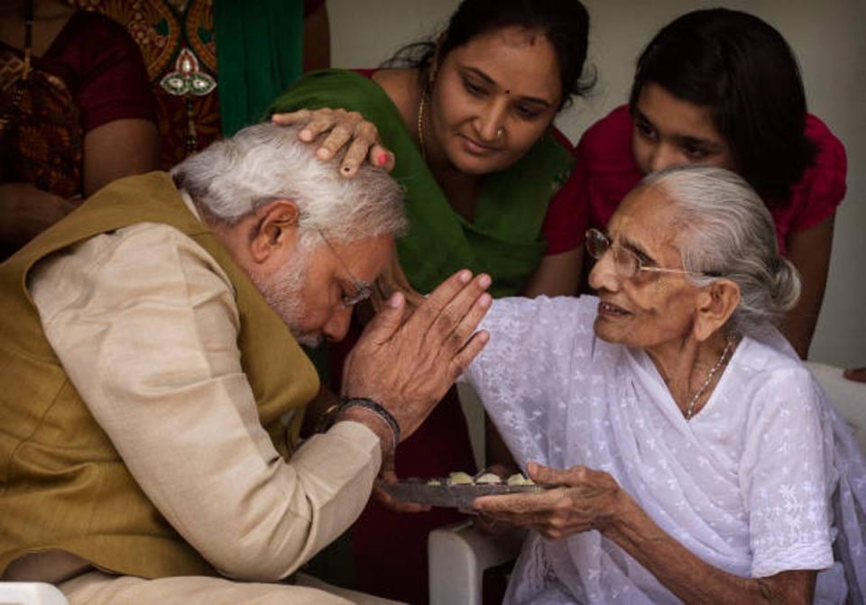 Narendra Modi is blessed by his mother Heeraben Modi in 2014 (Getty Images)