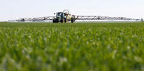 A tractor of the "Poschinger Bray'sche Gueterverwaltung" company applies out liquid at a wheat field in Irlbach near Deggendorf, Germany, April 21, 2016. REUTERS/Michaela Rehle