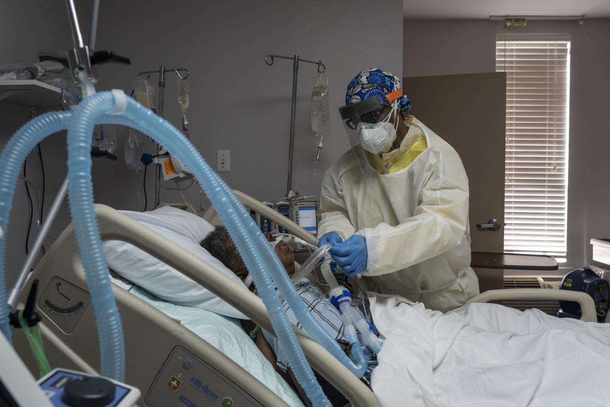 A member of the medical staff treats a patient in the COVID-19 intensive care unit at the United Memorial Medical Center on July 2, 2020 in Houston, Texas. COVID-19 cases and hospitalizations have spiked since Texas reopened, pushing intensive-care wards to full capacity and sparking concerns about a surge in fatalities as the virus spreads.