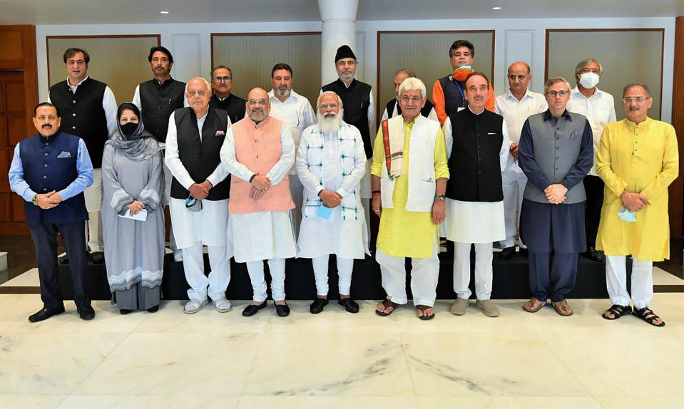 This photograph provided by the Prime Minister's Office shows members of various political parties with Indian Prime Minister Narendra Modi, center, and Home Minister Amit Shah, center left, in New Delhi, India, Thursday, June 24, 2021. India’s prime minister is holding a crucial meeting with pro-India politicians from disputed Kashmir on Thursday for the first time since New Delhi stripped the region’s semi-autonomy and jailed many of them in a crackdown. (Prime Minister's Office via AP)