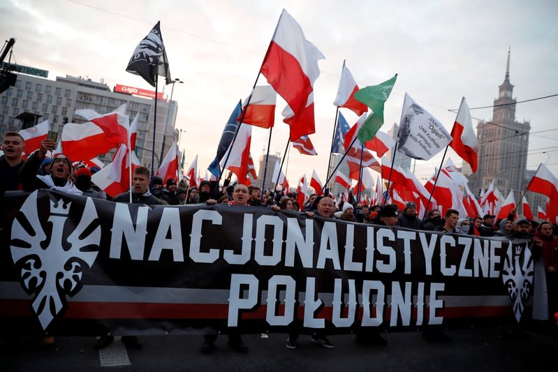 People carry a banner during a march marking the 101st anniversary of Polish independence in Warsaw