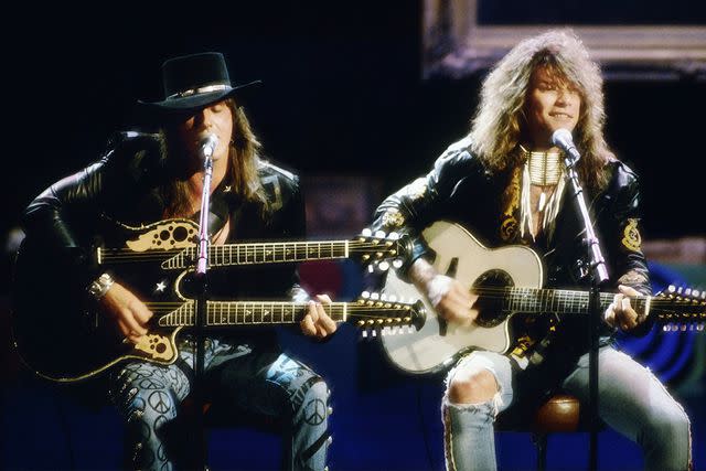 <p>Michael Ochs Archives/Getty </p> Richie Sambora and Jon Bon Jovi performing in 1989