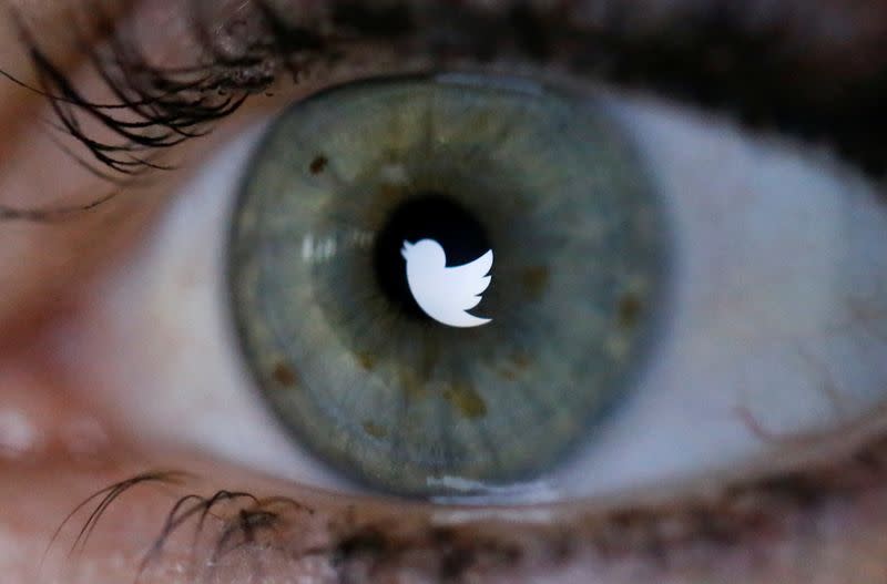 An illustration picture shows the Twitter logo reflected in the eye of a woman in Berlin