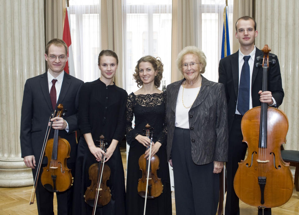 In this Aug. 31, 2012 photo provided by the Austrian parliament 95 year-old soprano Hilde Zadek, second right, poses with musicians of the Tritonius Arts Quartett after being awarded with the Great Medal of Honor of the Austrian Republic, at the parliament in Vienna, Austria. For Zadek, the city she once despised as part of Hitler's evil empire has long become a home that she says she would never leave _ and one that is proud to call her own. She has been showered with medals, granted high honorary titles and a singer's competition named after her 13 years ago has turned into an international launching pad for future opera stars. (AP Photo/Parlamentsdirektion/Bildagentur Zolles KG/Jacqueline Godany)