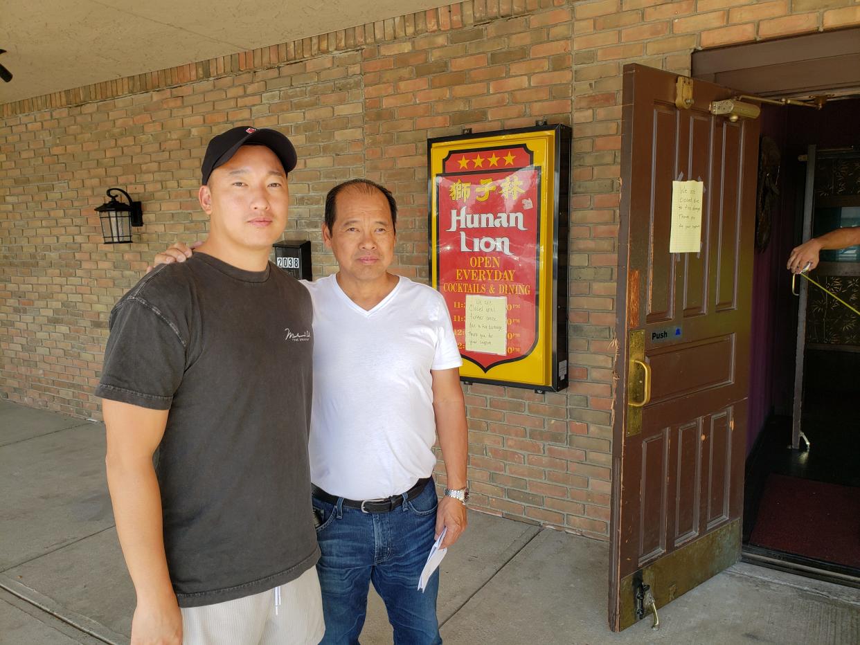 Steven Chang and his father, Jason Chang, greeted customers at the family's restaurant, Hunan Lion, on Wednesday to tell them a fire will keep the restaurant closed for three to six months.