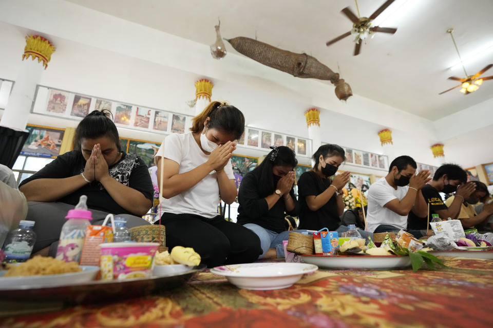 Relatives of the victims of a mass killing attack gather for a Buddhist ceremony Wat Rat Samakee temple in Uthai Sawan, northeastern Thailand, Monday, Oct. 10, 2022. A former police officer facing a drug charge burst through a locked door at a day care center in northeastern Thailand, killing dozens of preschoolers and teachers and then shooting more people as he fled. (AP Photo/Sakchai Lalit)