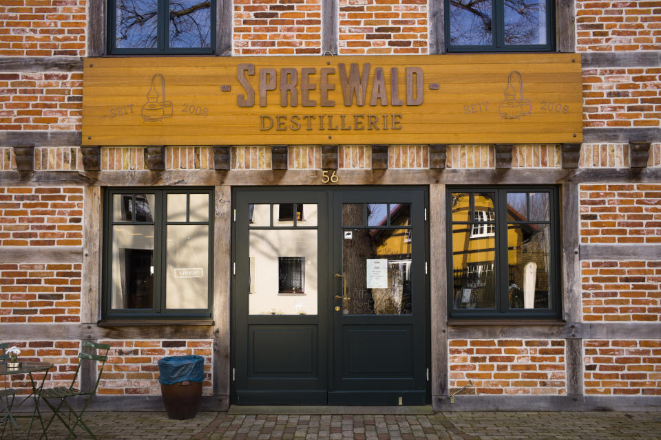 In this Thursday, Feb. 28, 2019 photo, a wooden nameplate displayed on the main entrance of a historical reconstructed building of the German whiskey maker Spreewood Distillery in Schlepzig, Germany. (AP Photo/Markus Schreiber)