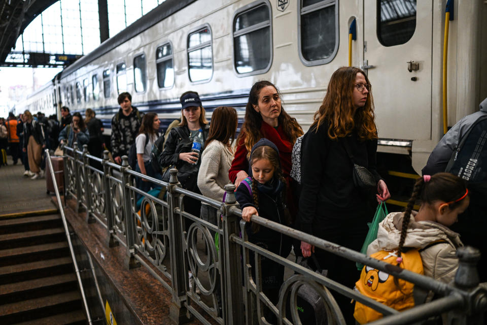 Ukrainians wait to board a train 