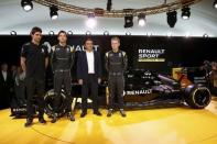 Renault Chief Executive Carlos Ghosn (2ndR), Renault Formula One racing driver Kevin Magnussen of Denmark (R) and teammate Jolyon Palmer of Britain (2ndL), and reserve driver Esteban Ocon (L) pose during the official presentation of the new Renault RS16 car at the company's research center, the Technocentre, in Guyancourt, near Paris, France, February 3, 2016. REUTERS/Benoit Tessier