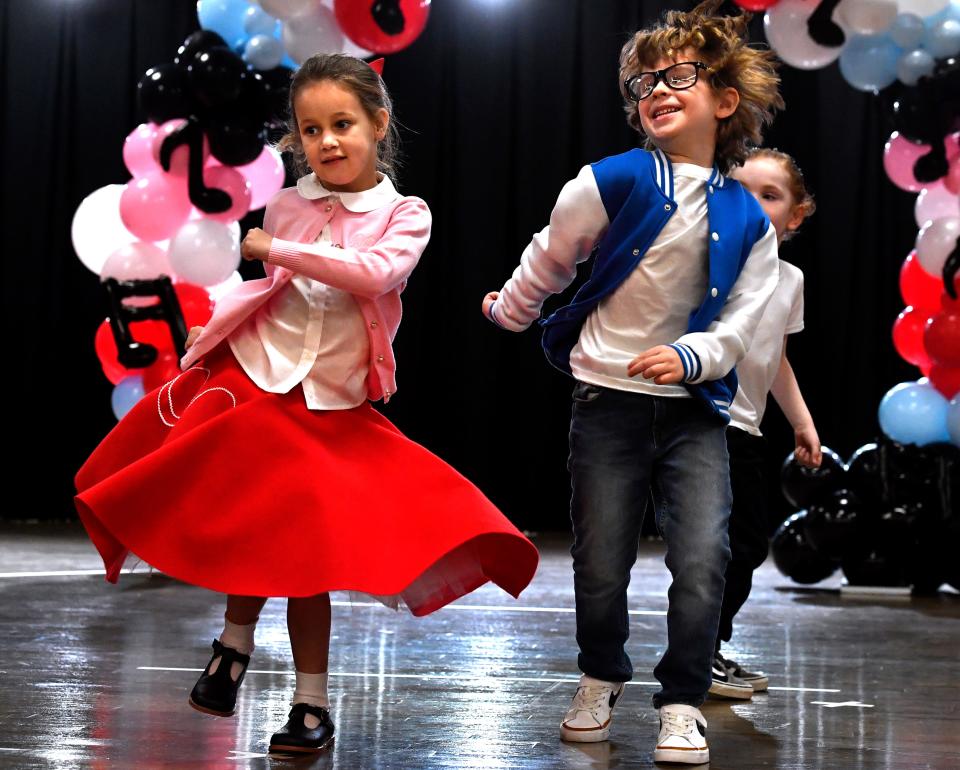 Kindergartners Darcy Poindexter (left) and Oak Fenoglio dance the Twist with classmates during Austin Elementary School’s annual Fifties Day Friday Jan. 26, 2024.