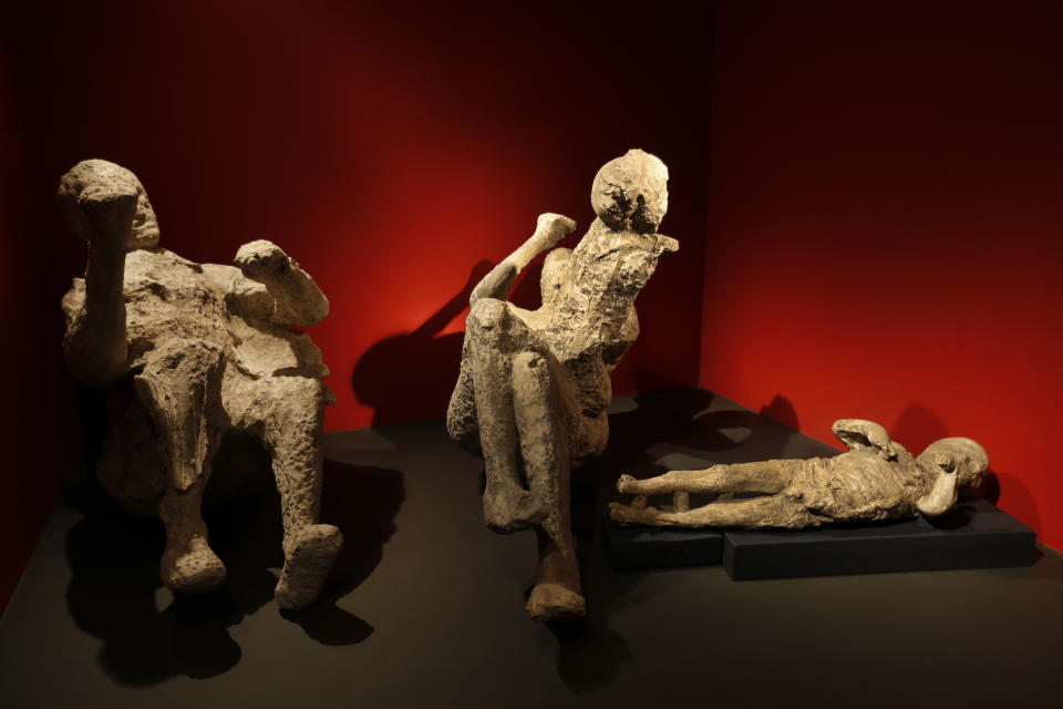 Casts of a family of two adults and two children who died together in an alcove in Pompeii, made by filling plaster in the void left by their bodies, are seen during a photo call for the upcoming exhibition entitled 'Life and death Pompeii and Herculaneum', at the British Museum in central London, Tuesday, March 26, 2013. The exhibition about the two Roman cities, buried by a catastrophic volcanic eruption of Mount Vezuvius in 79 AD, will run at the museum from March 28 to Sept. 29, 2013. (AP Photo/Lefteris Pitarakis)