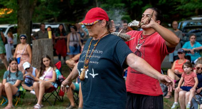 Shelley DePaul, left, chief of education of the Lenape Nation of Pennsylvania, goes through the tradition of smudging by Coyote Acevedo during a stop in Milford Borough, New Jersey, across the Delaware River from Bucks County, on Thursday, Aug. 11, 2022. The ceremony was part of a monthlong river journey celebrating the 20th anniversary of the signing of a treaty of renewed brotherhood between members of the Lenape Nation and organizations along the Delaware River.
