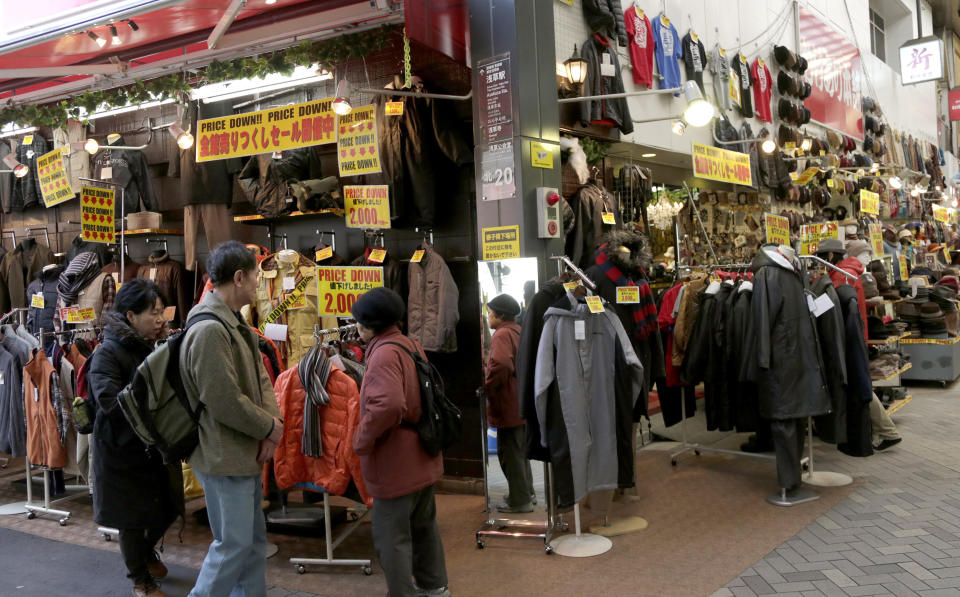 In this Monday, Feb. 17, 2014 photo, people look around a clothing store in Tokyo. Japan's consumer price index rose 1.3 percent in January and factory production also climbed, suggesting the recovery in the world's third-largest economy is holding steady ahead of an April 1 tax hike. A raft of data released Friday suggest the economy may need still more help in weathering the 3 percent tax increase in April as many economists forecast a contraction will follow as consumers and businesses adjust to higher costs. (AP Photo/Shizuo Kambayashi)