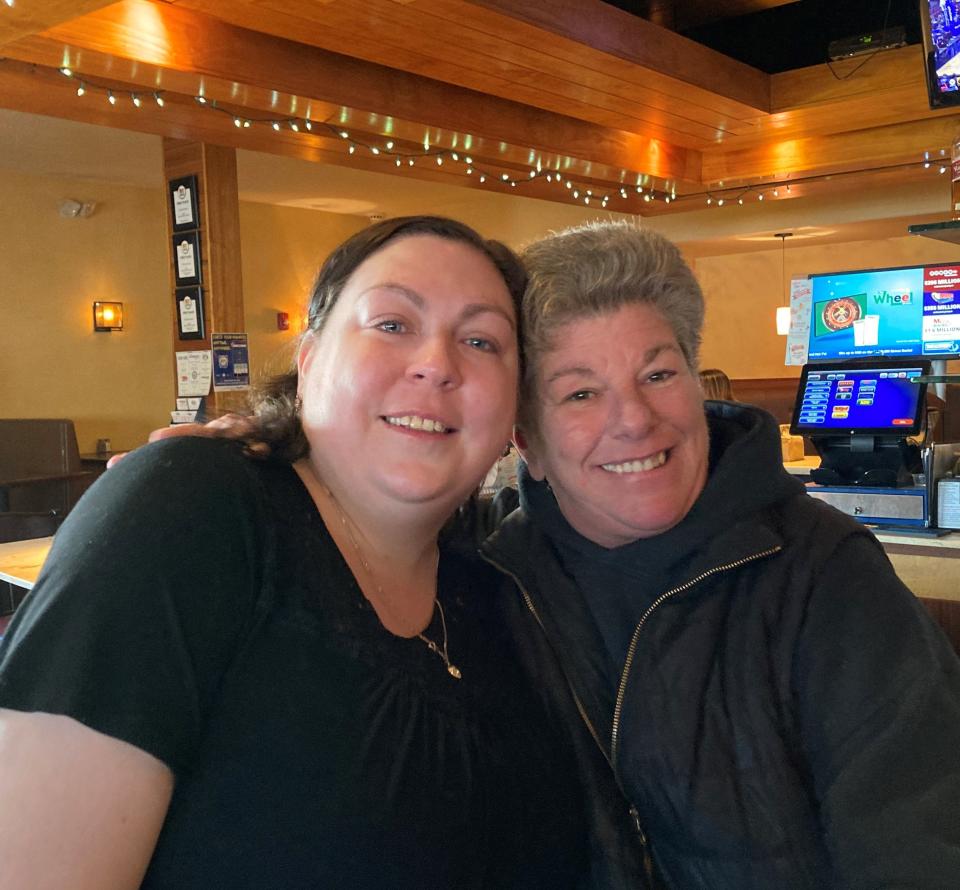 Bartender and server Melissa Bicchieri poses with Deb Page, a restaurant regular who made sure she stopped in to say goodbye to the owner Nusa Dimopoulos and the staff of Zorba's Taverna on Stafford Street on its closing day, Saturday.
