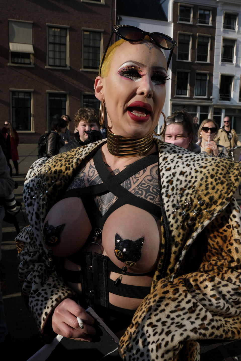 Sex workers carry signs protesting unequal treatment and stigmatizing during a demonstration in The Hague, Netherlands, Tuesday, March 2, 2021. Stores in one village opened briefly, cafe owners across the Netherlands were putting tables and chairs on their outdoor terraces and sex workers demonstrated outside parliament in protests against the government's tough coronavirus lockdown. (AP Photo/Patrick Post)