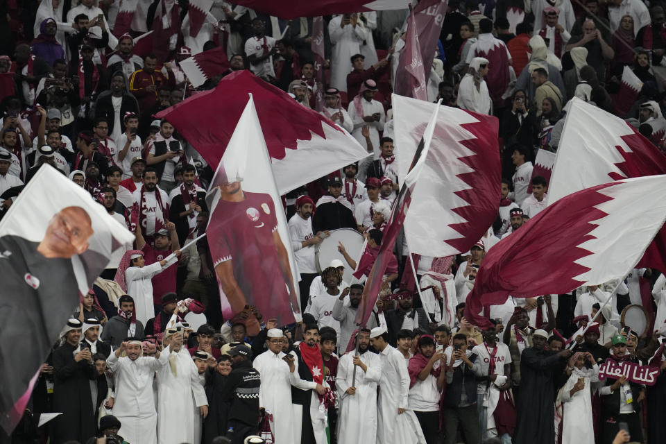 Qatar supporters celebrate after their team's win in the Asian Cup quarterfinal soccer match between Qatar and Uzbekistan at Al Bayt Stadium in Al Khor, Qatar, Saturday, Feb. 3, 2024. (AP Photo/Aijaz Rahi)