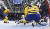 Sweden's goalie Valentina Wallner is beaten by a shot from Team USA's Monique Lamoureux (not shown) during the second period of their women's semi-final ice hockey game at the Sochi 2014 Winter Olympic Games, February 17, 2014. REUTERS/Bruce Bennett/Pool