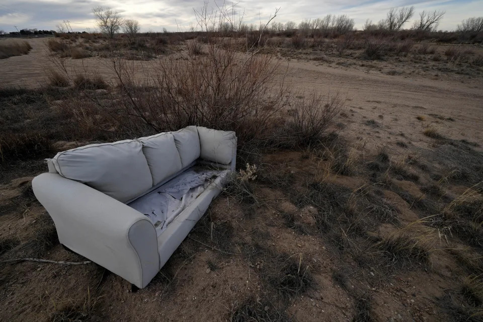 A discarded couch litters the dry bed of the Arkansas River Thursday, Jan. 5, 2023, near Garden City, Kan. The river in western Kansas is mostly dry after decades of extensive groundwater use and periodic droughts. Lawmakers are looking to take up groundwater issues in western Kansas in the upcoming session as the Kansas Water Authority is urging stricter usage measures to try to slow the steady decline of water levels in the Ogallala Aquifer. (AP Photo/Charlie Riedel)