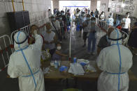 Medical workers takes throat swab samples in new round of COVID-19 testing in Nanjing city in eastern China's Jiangsu province Monday, Aug. 2, 2021 The current coronavirus outbreaks in China, while still in the hundreds of cases in total, have spread much more widely than previous ones, reaching multiple provinces and cities including the capital, Beijing. Many of the cases have been identified as the highly contagious delta variant that is driving a resurgence in many countries. (Chinatopix via AP)