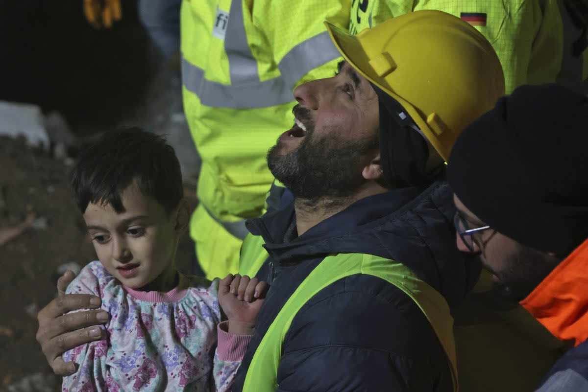 A 33 year-old mother, Serap Topal and her 5 year-old son, Mehmet Hamza Topal are rescued by the German and British rescue teams from under the rubble after 68 hours of the 7.7 magnitude Kahramanmaras earthquake in Turkey (Anadolu Agency via Getty Images)