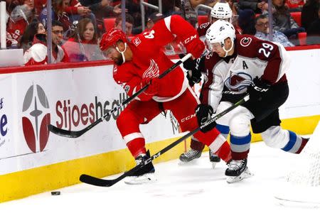 Nov 19, 2017; Detroit, MI, USA; Detroit Red Wings right wing Luke Glendening (41) and Colorado Avalanche center Nathan MacKinnon (29) battle for the puck in the second period at Little Caesars Arena. Rick Osentoski-USA TODAY Sports