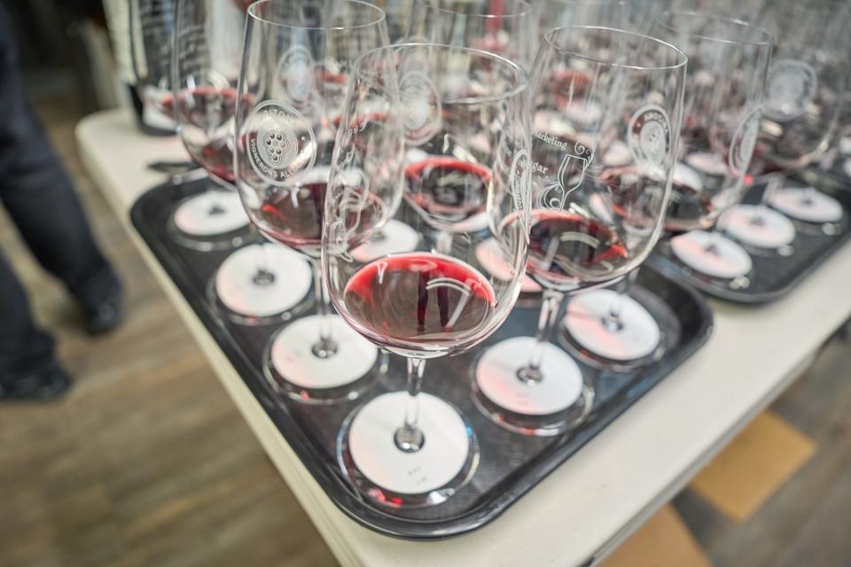 Red wines lined up on a serving tray wait to be taken to the judging tables during the 2023 azcentral Arizona Wine Competition on Feb. 27, 2023, at The Newton in Phoenix.