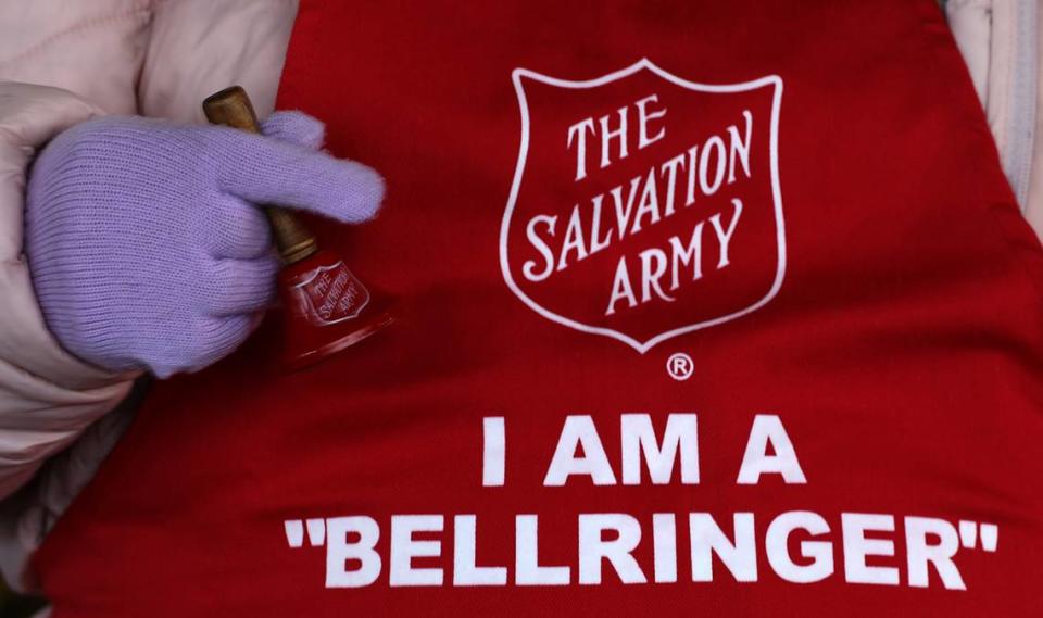 Salvation Army bellringer Consuelo Luna stands near a Red Kettle inside the entryway to a grocery store on Road 68 in west Pasco.