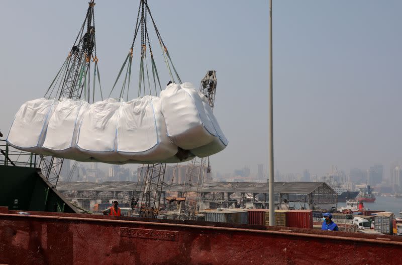 Humanitarian aid donated by World Food Program (WFP), are unloaded at Beirut's port