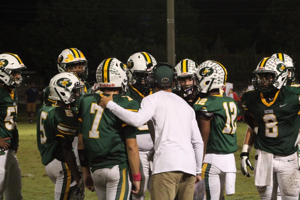 Glades Day football huddles during a first round state tournament game on Nov. 12, 2021. The Gators defeated Westminster Academy 38-0 in the Class 2A region quarterfinal contest.